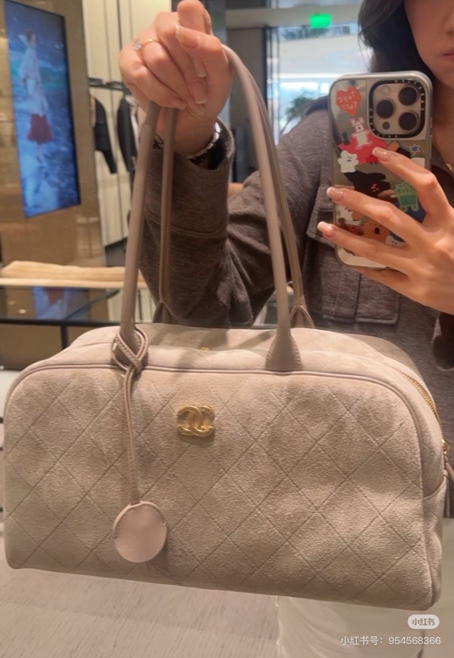 Chanel Diamond-Quilted Bowling Bag with Round Charm — model