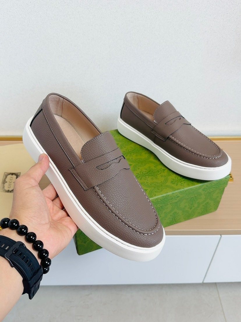 Gucci White-Sole Penny Loafers — model